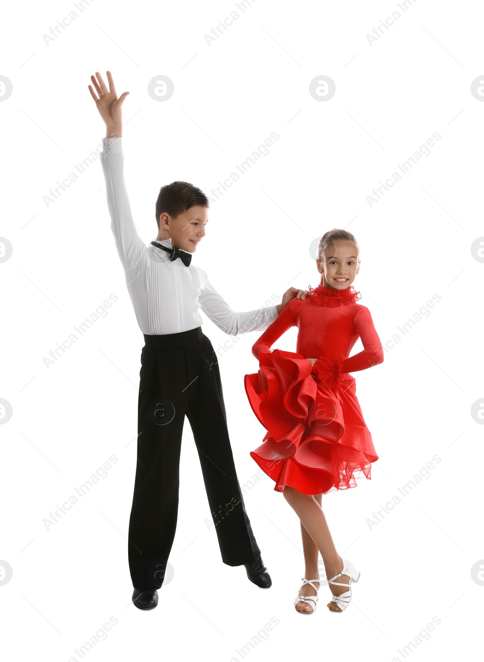 Photo of Beautifully dressed couple of kids dancing on white background