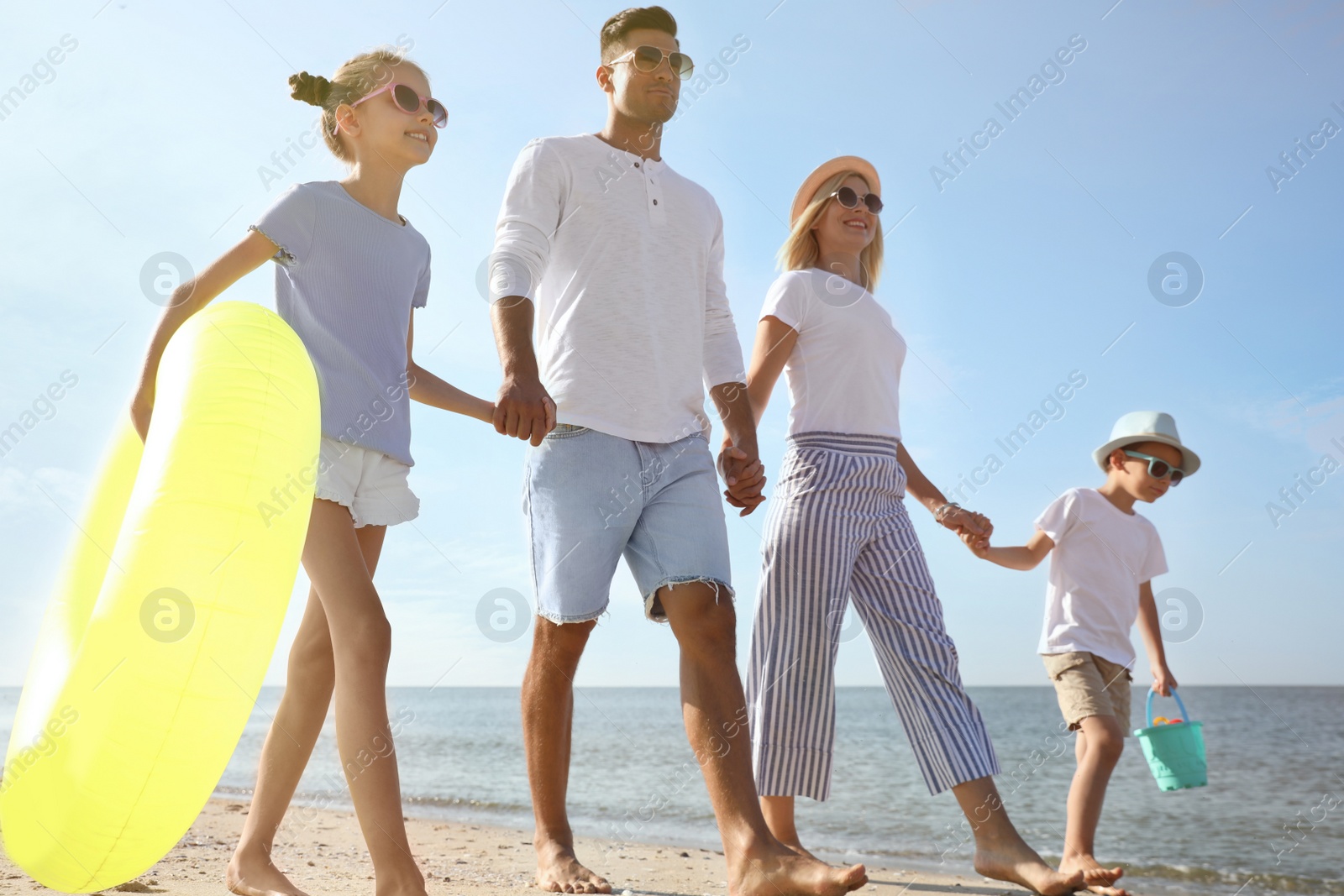 Photo of Happy family at beach on sunny summer day