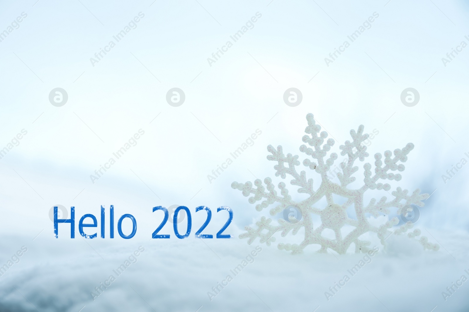 Image of Hello 2022. Beautiful decorative snowflake in white snow 