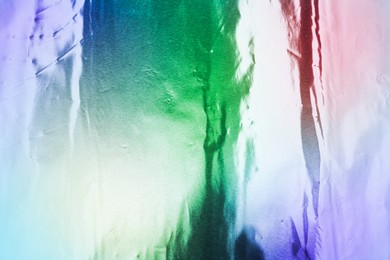 Image of Beautiful colorful foil as background, top view