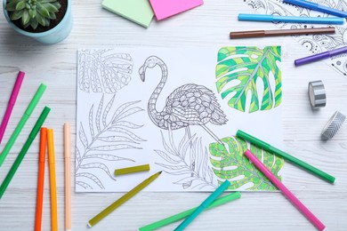 Antistress coloring page and felt tip pens on white wooden table, flat lay