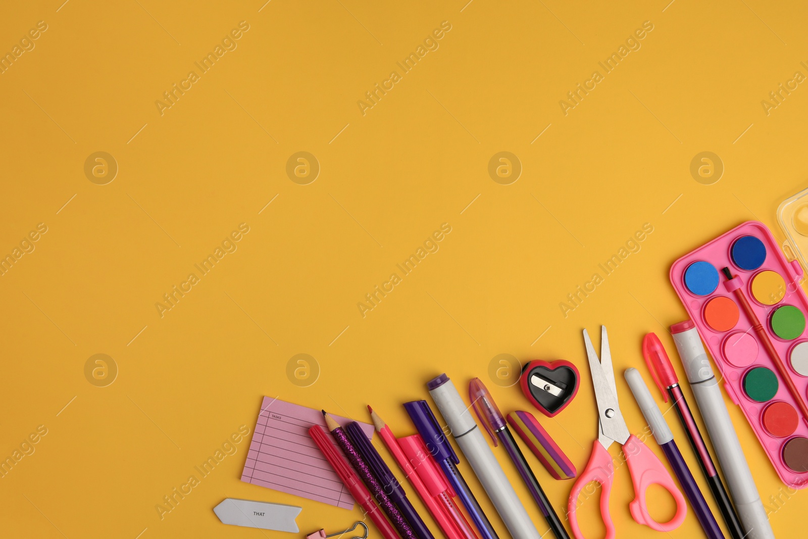 Photo of Flat lay composition with different school stationery on orange background, space for text. Back to school