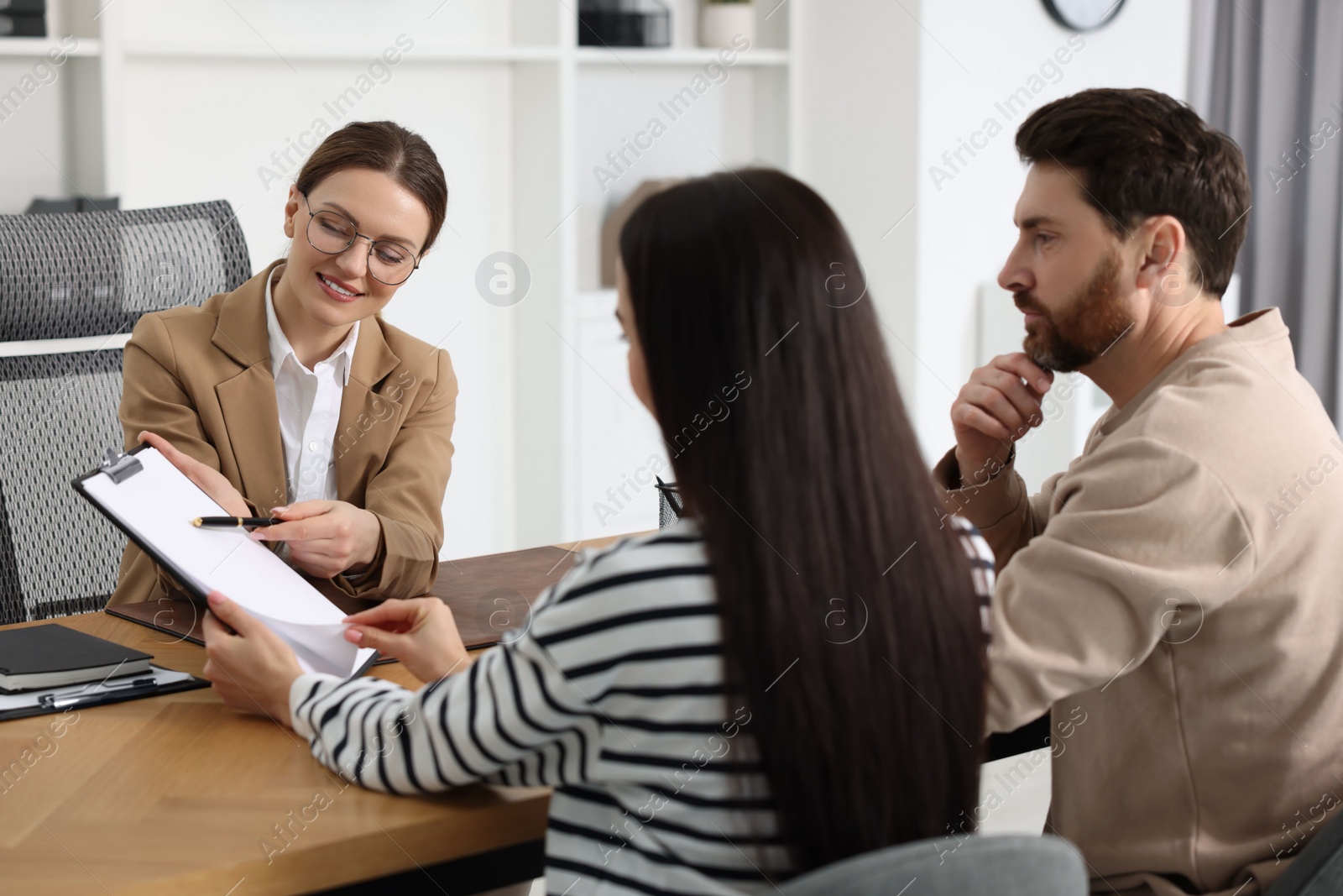 Photo of Couple having meeting with lawyer in office