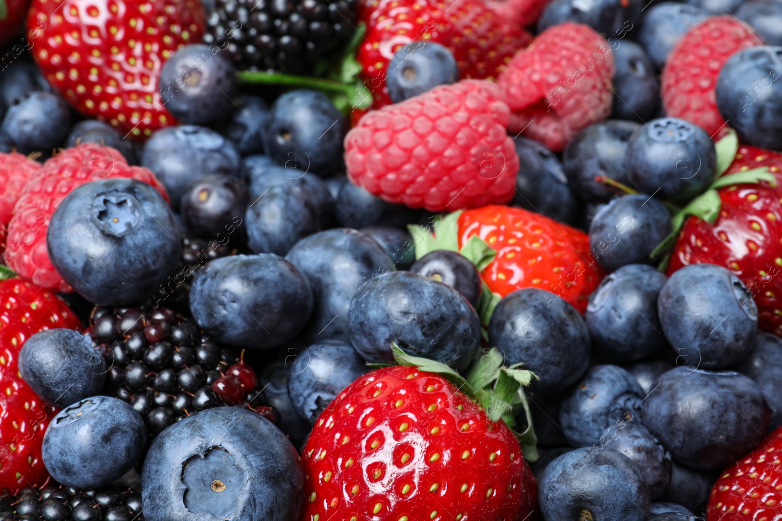 Photo of Mix of different ripe tasty berries as background, closeup view