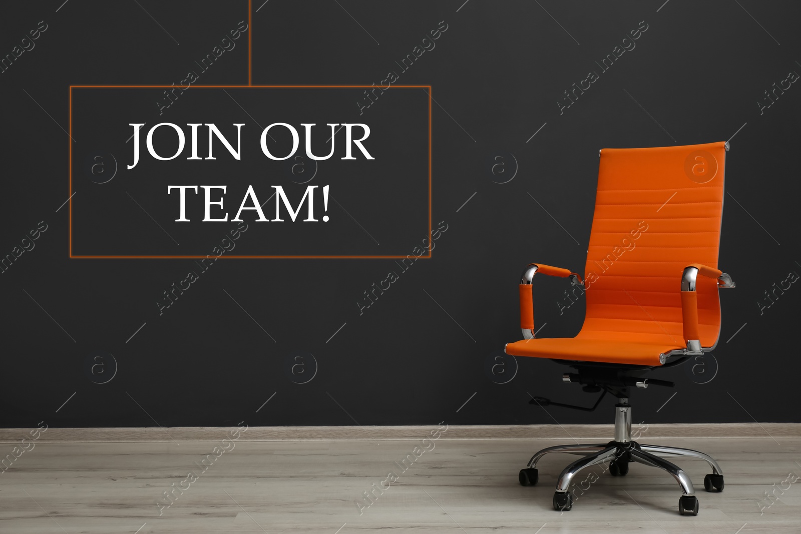 Image of Join our team! Orange office chair near black wall indoors