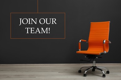 Join our team! Orange office chair near black wall indoors