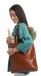 Young woman with leather shopper bag on white background