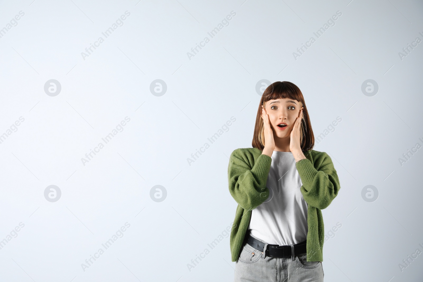 Photo of Portrait of emotional girl on white background. Space for text