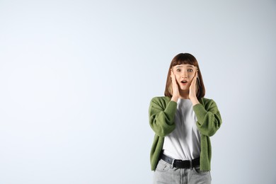 Photo of Portrait of emotional girl on white background. Space for text