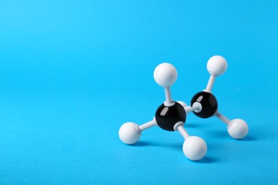 Photo of Molecule of alcohol on light blue background, space for text. Chemical model