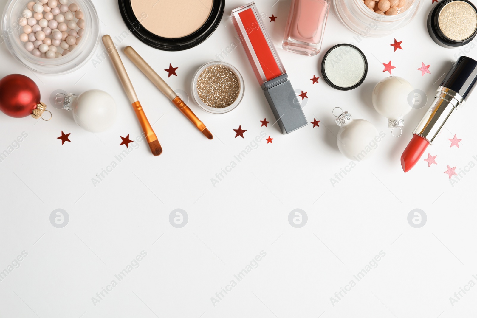 Photo of Flat lay composition with makeup products and Christmas decor on white background. Space for text