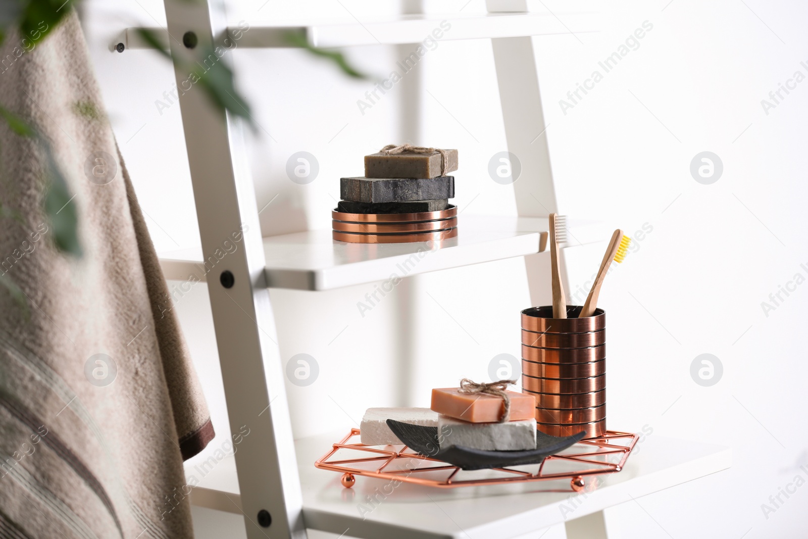 Photo of Soap and toiletries on wooden shelves in bathroom