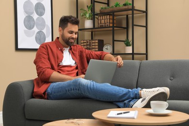 Man using laptop for online shopping at home