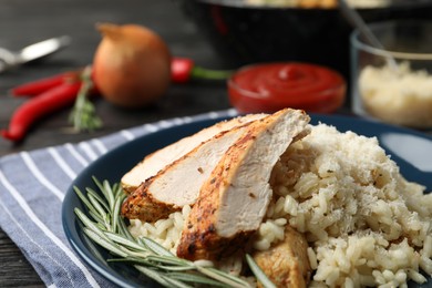 Delicious risotto with chicken on plate, closeup