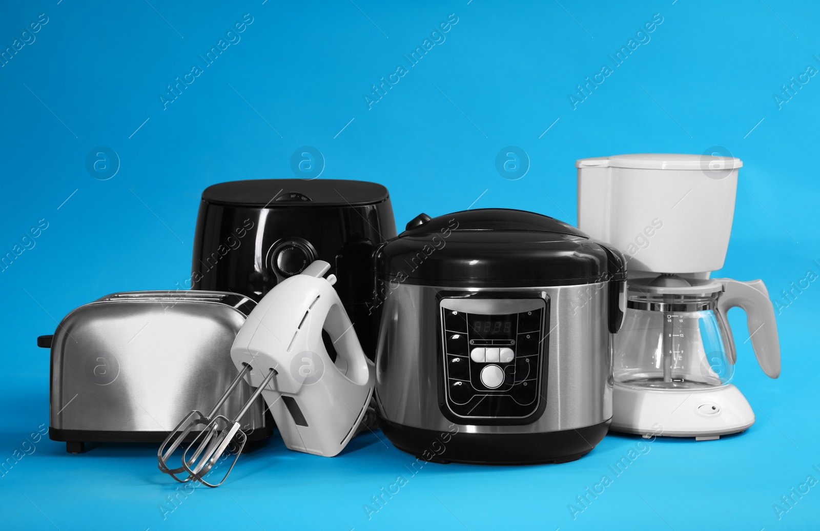 Photo of Set of different household appliances on light blue background