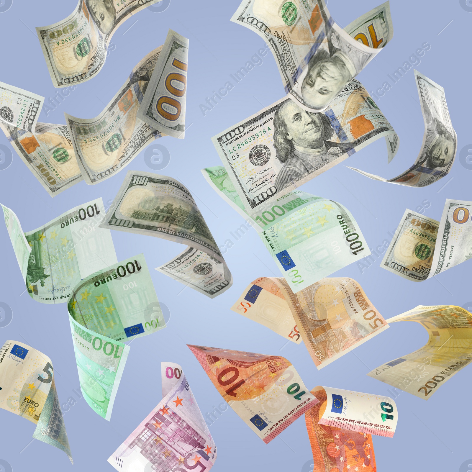 Image of Money exchange. Many dollars and euro banknotes falling on light blue background