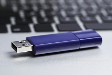 Photo of Usb flash drive on laptop, closeup view