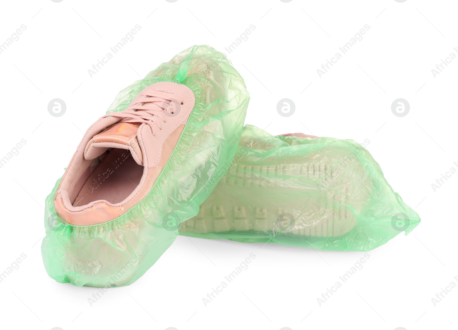 Photo of Sneakers in green shoe covers isolated on white