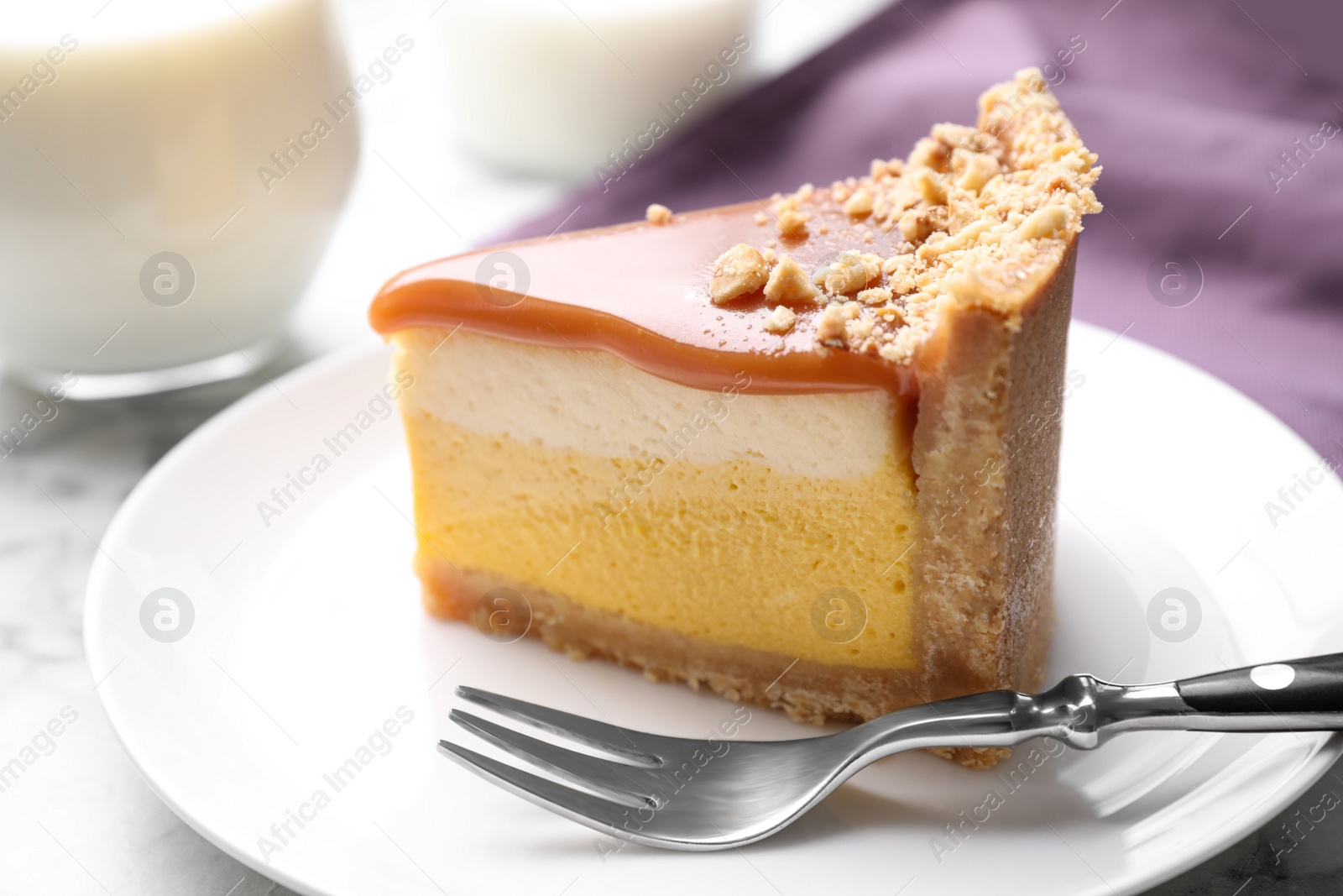 Photo of Piece of delicious cake with caramel on plate, closeup