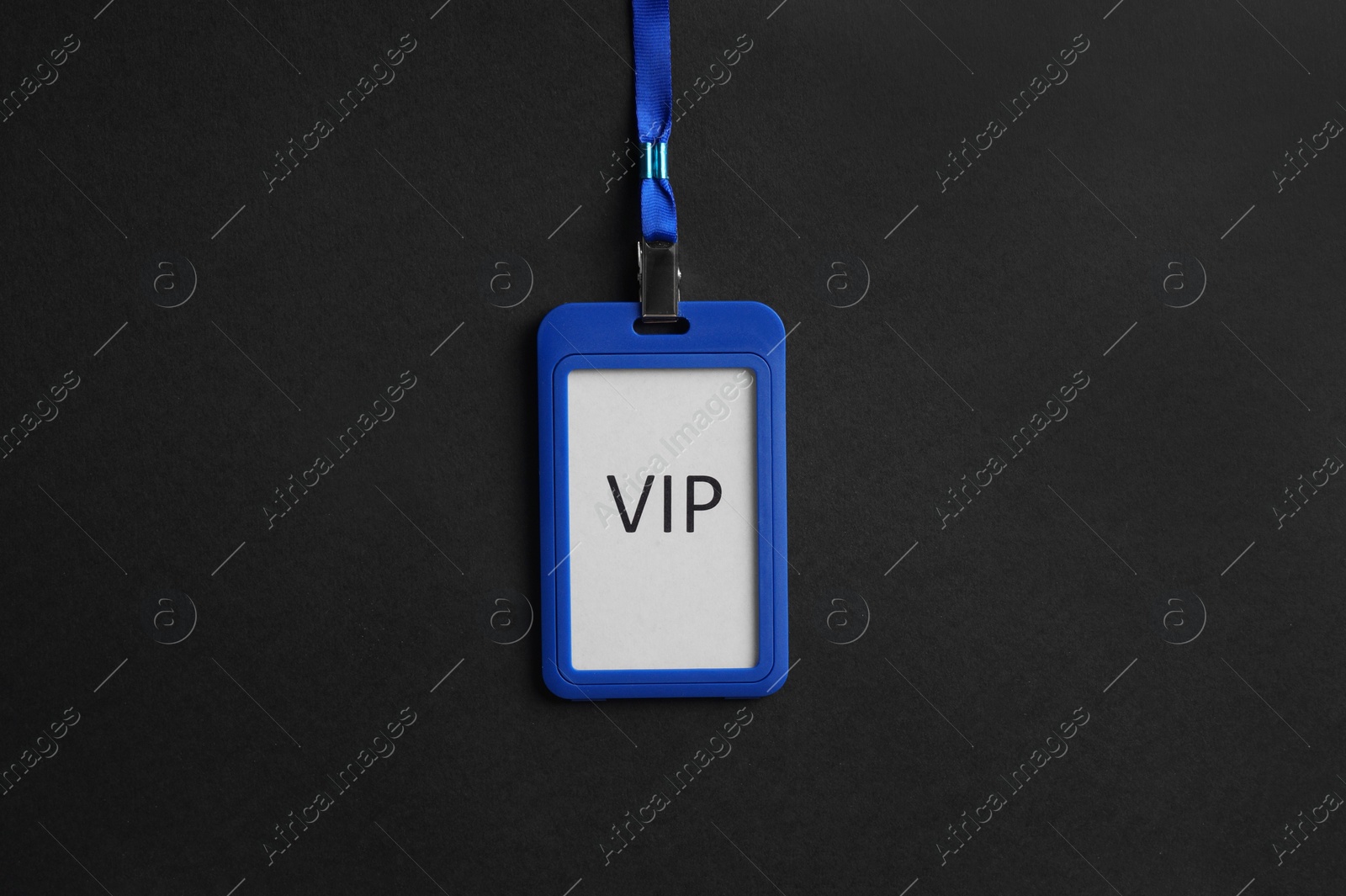 Photo of Plastic vip badge on black background, top view