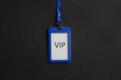 Plastic vip badge on black background, top view