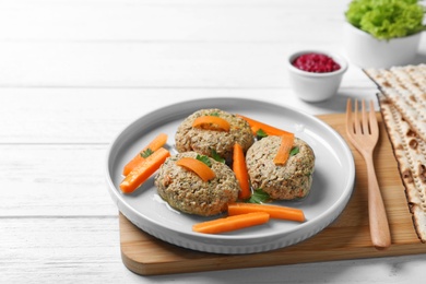 Photo of Plate of traditional Passover (Pesach) gefilte fish on wooden background