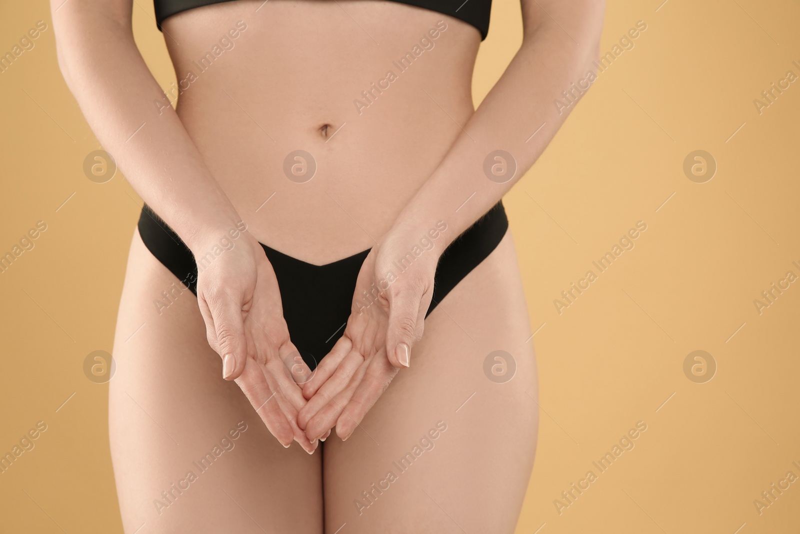 Photo of Gynecology. Woman in underwear on yellow background, closeup