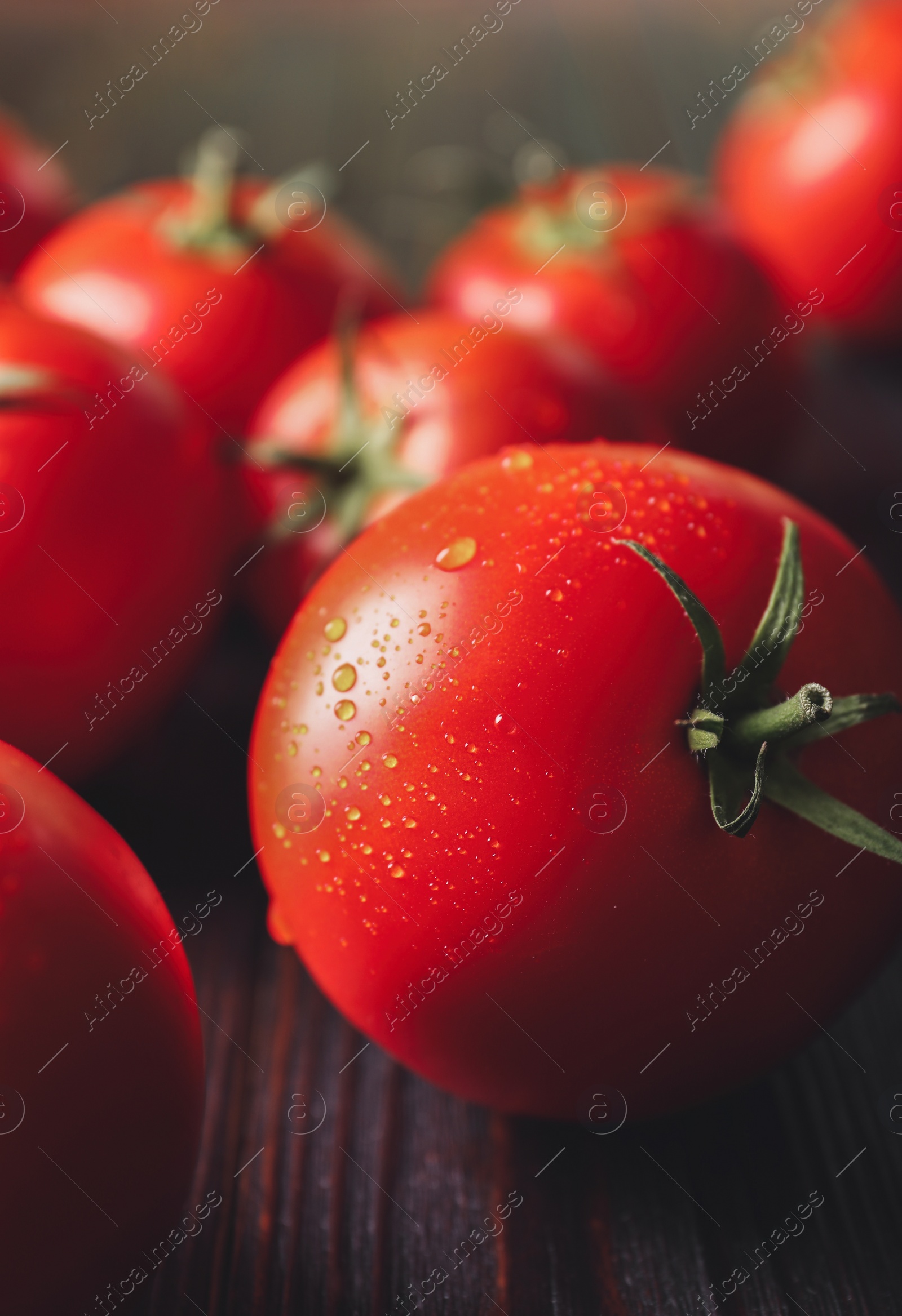 Photo of Fresh ripe tomatoes on wooden table, closeup