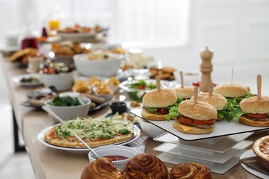 Photo of Brunch table setting with different delicious food indoors