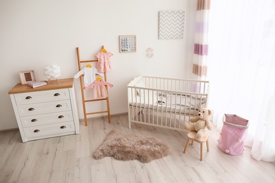 Photo of Cozy baby room interior with crib