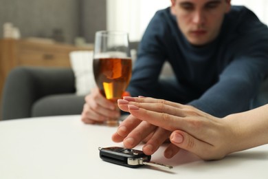 Photo of Woman stopping drunk man from taking car keys, closeup. Don't drink and drive concept