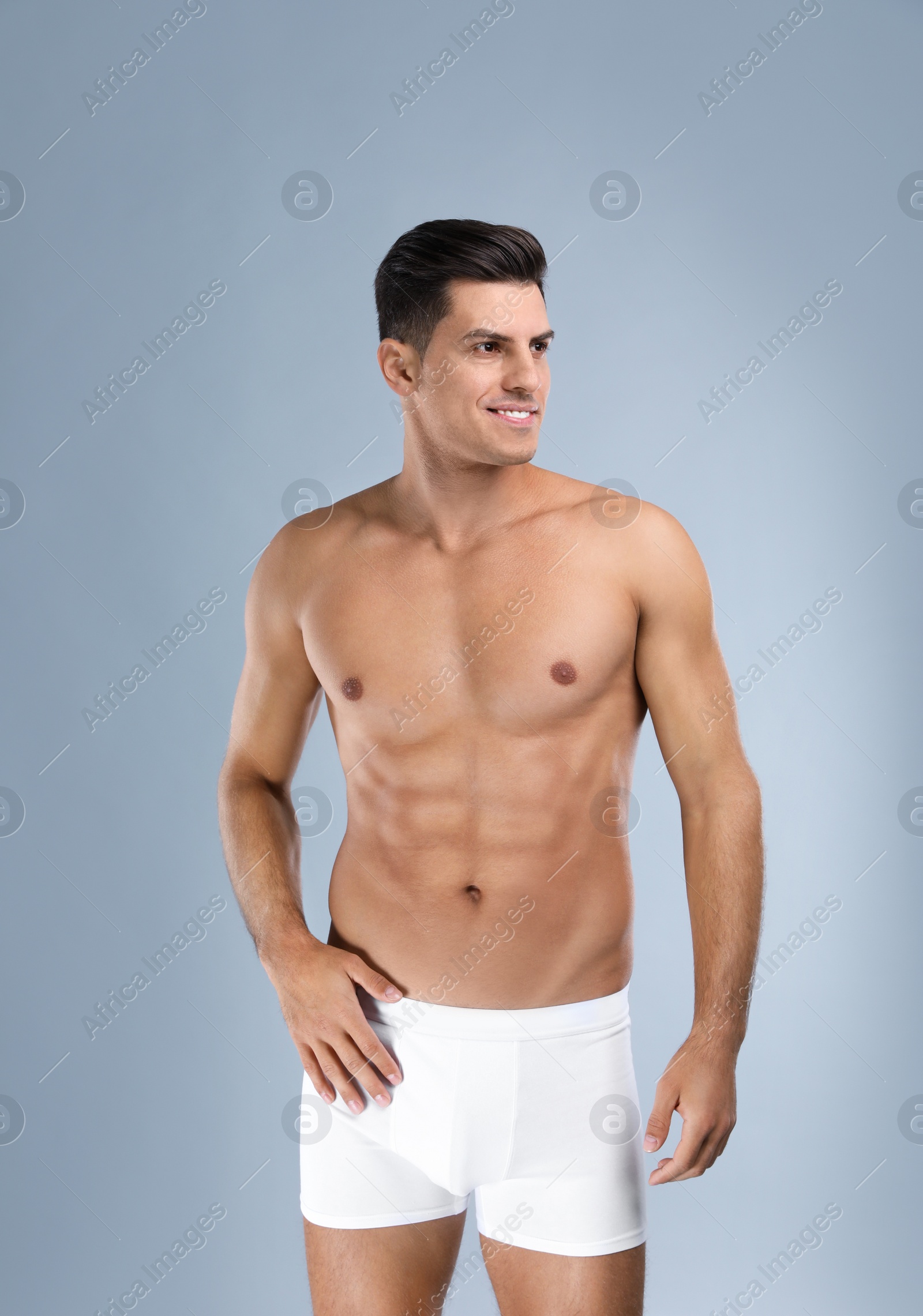 Photo of Handsome man in white underwear on light grey background