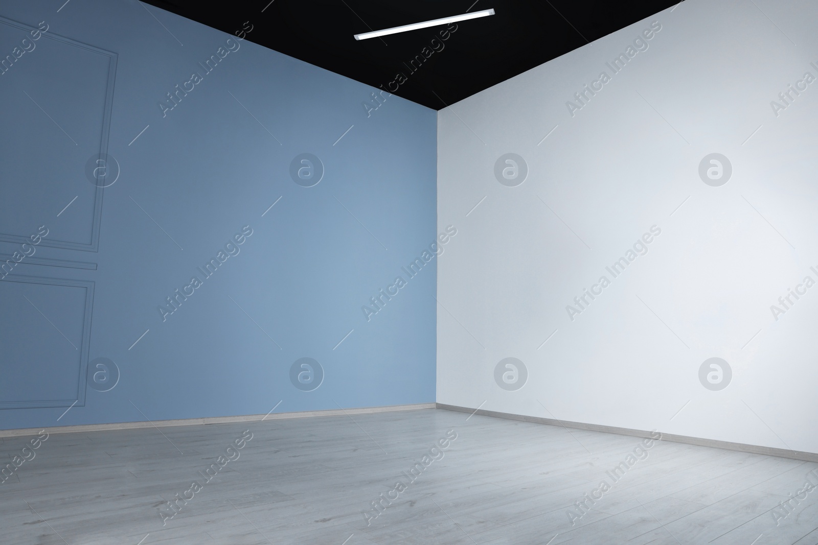 Photo of Empty renovated room with light walls and power outlet sockets