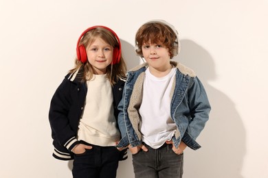 Photo of Fashion concept. Stylish children posing on white background
