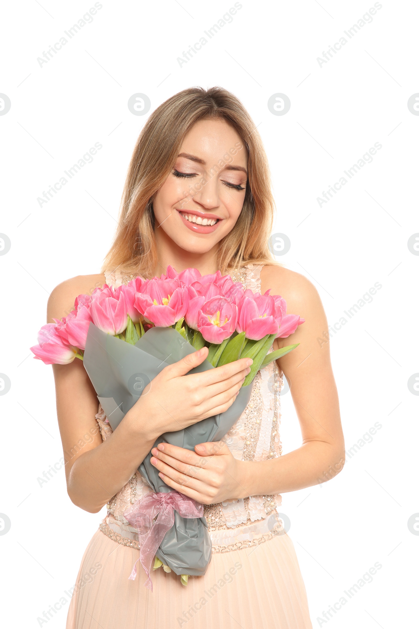 Photo of Portrait of smiling young girl with beautiful tulips on white background. International Women's Day