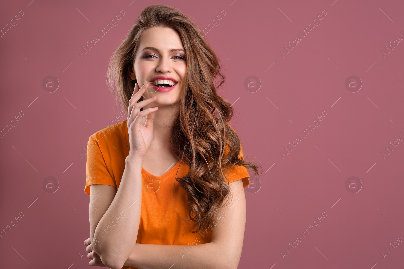 Photo of Portrait of young woman with long beautiful hair on color background