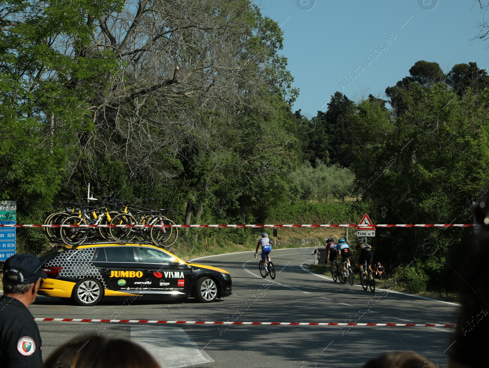 Photo of JESI, ITALY - MAY 17, 2022: Cyclists and team car during stage 10 of Giro d`Italia 105 bicycle race