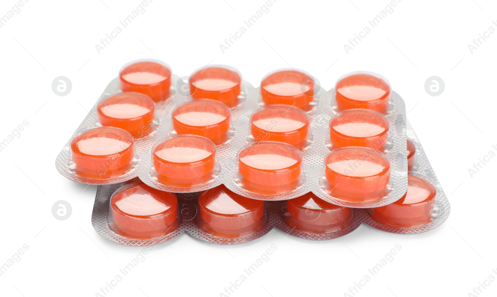 Photo of Blisters with orange cough drops on white background