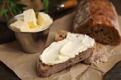 Tasty bread with butter on table, closeup