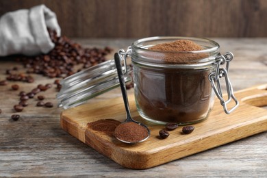 Photo of Glass jar of instant coffee and spoon on wooden table