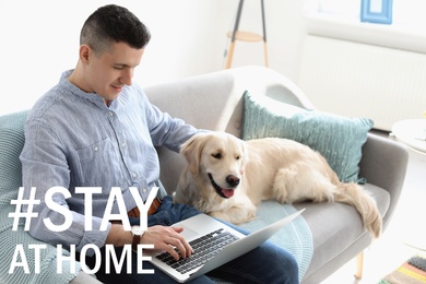 Image of Hashtag Stay At Home - protective measure during coronavirus pandemic. Man with adorable dog working on laptop in living room 