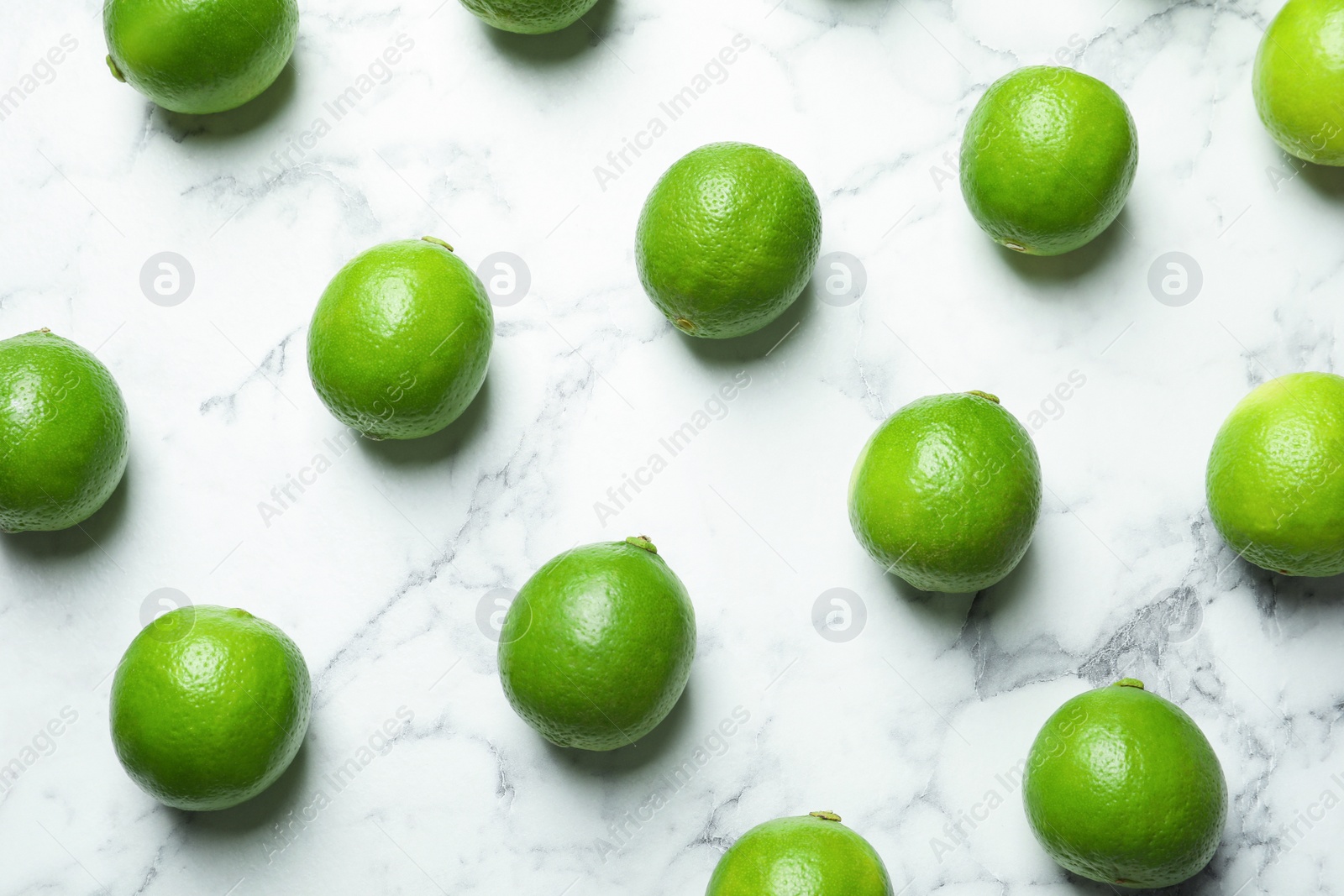 Photo of Fresh ripe green limes on marble background
