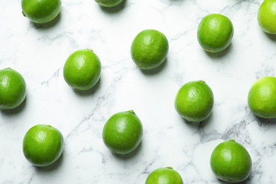 Photo of Fresh ripe green limes on marble background