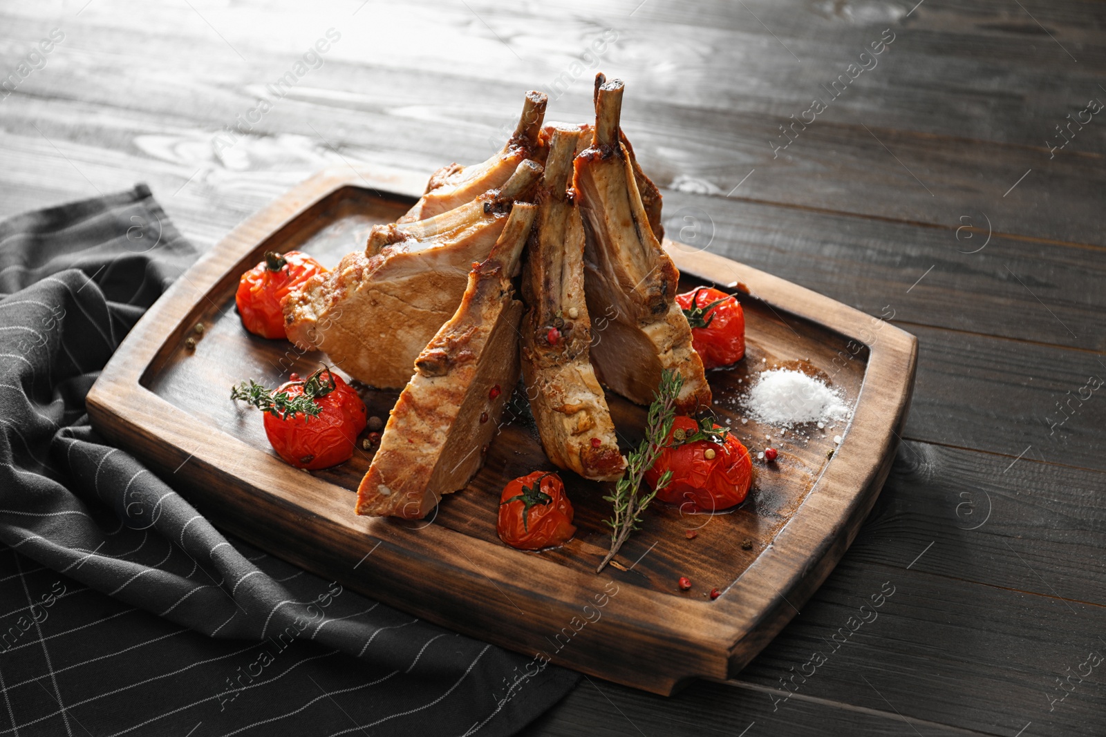 Photo of Delicious roasted ribs served on wooden table