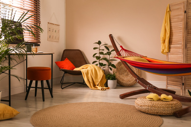 Photo of Colorful hammock with pillow in modern room interior