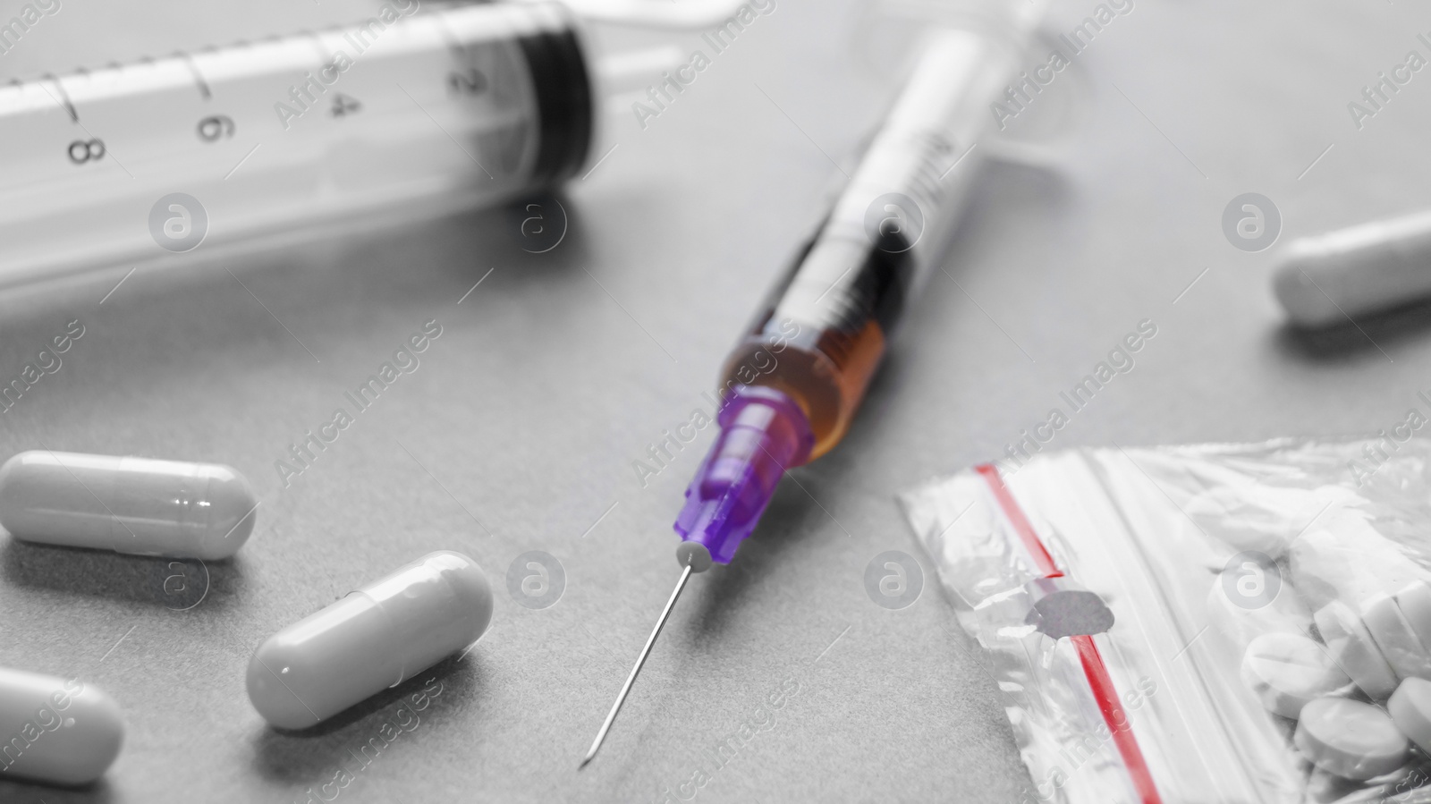 Photo of Different hard drugs on grey table, closeup