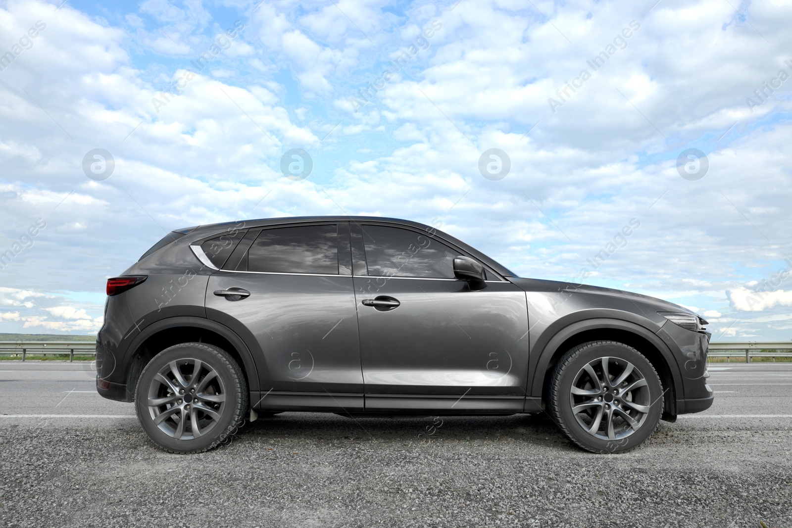 Photo of New black modern car on asphalt road