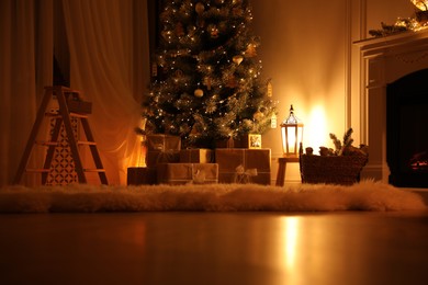 Photo of Beautiful Christmas tree with gifts in dimly lit room