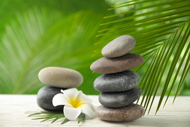 Photo of Composition with stones on table against blurred background. Zen concept