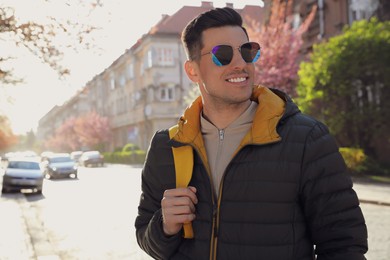 Photo of Happy male tourist sightseeing outdoors on spring day